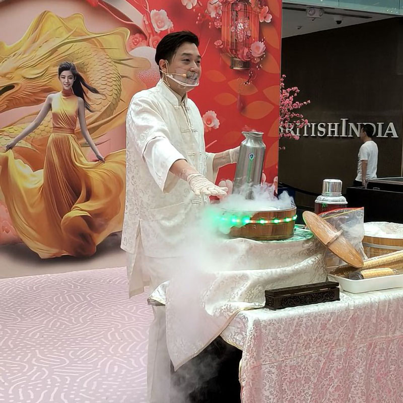 Roger Poon making dragon's beard on stage